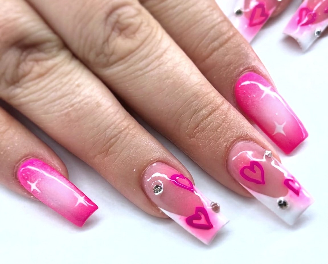 Pink heart nail art with rhinestones